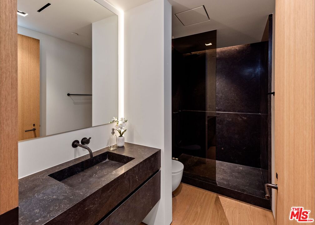 1663 Summitridge Drive Beverly Hills, CA 90210 - Photo 38 of 41 a bathroom with a sink and a mirror