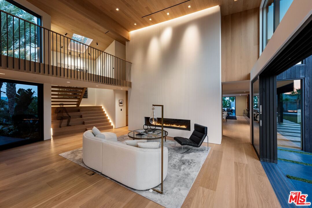 1663 Summitridge Drive Beverly Hills, CA 90210 - Photo 5 of 41 a living room with furniture and a fireplace