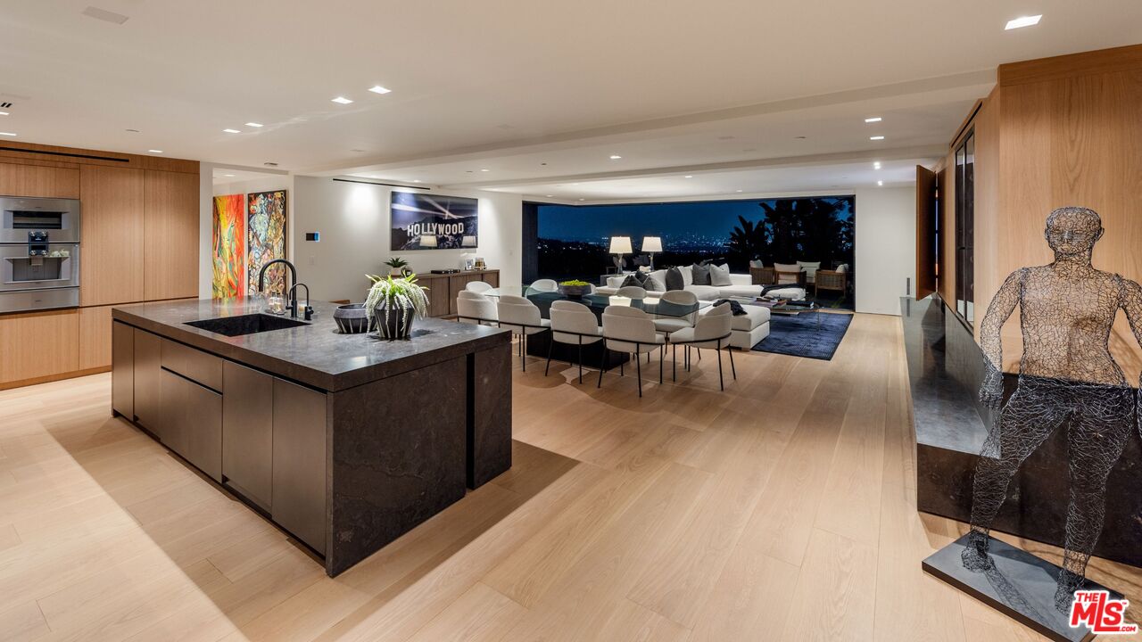1663 Summitridge Drive Beverly Hills, CA 90210 - Photo 7 of 41 a living room with furniture and a wooden floor