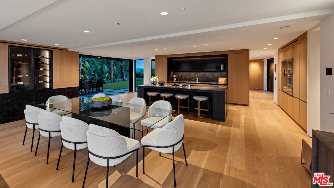 1663 Summitridge Drive Beverly Hills, CA 90210 - Photo 8 of 41 a living room with furniture a flat screen tv and floor to ceiling window