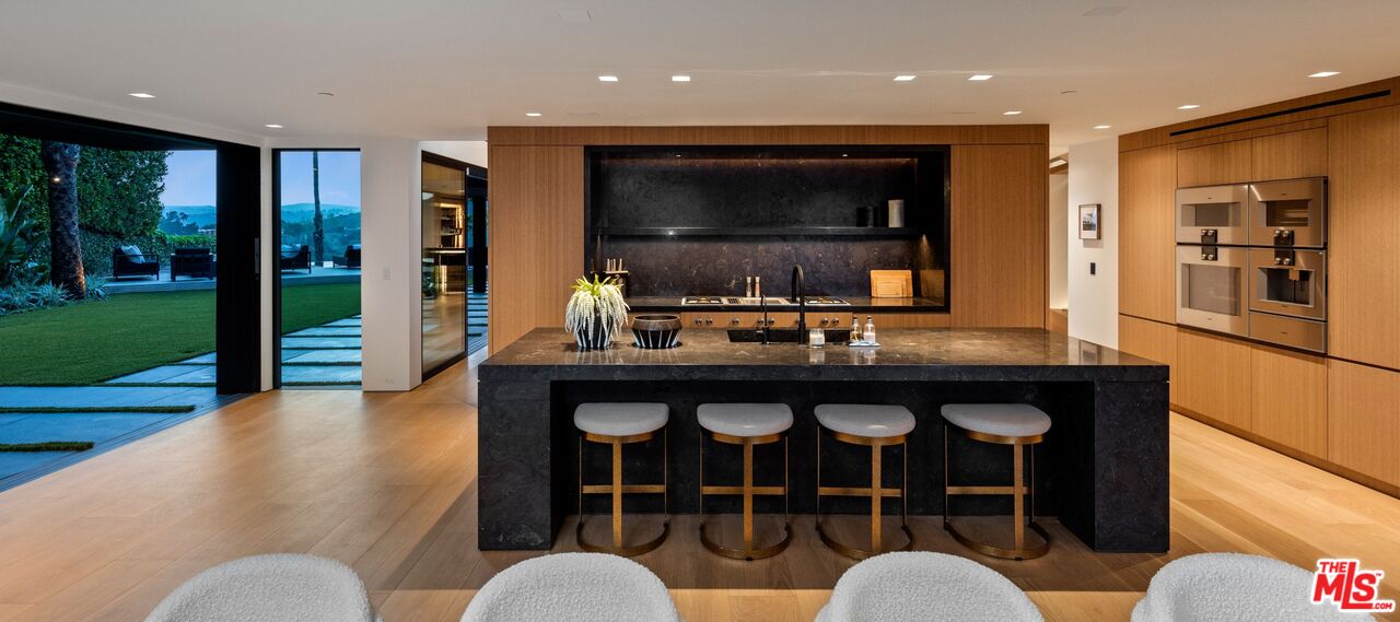 1663 Summitridge Drive Beverly Hills, CA 90210 - Photo 9 of 41 a living room with furniture a flat screen tv and a fireplace