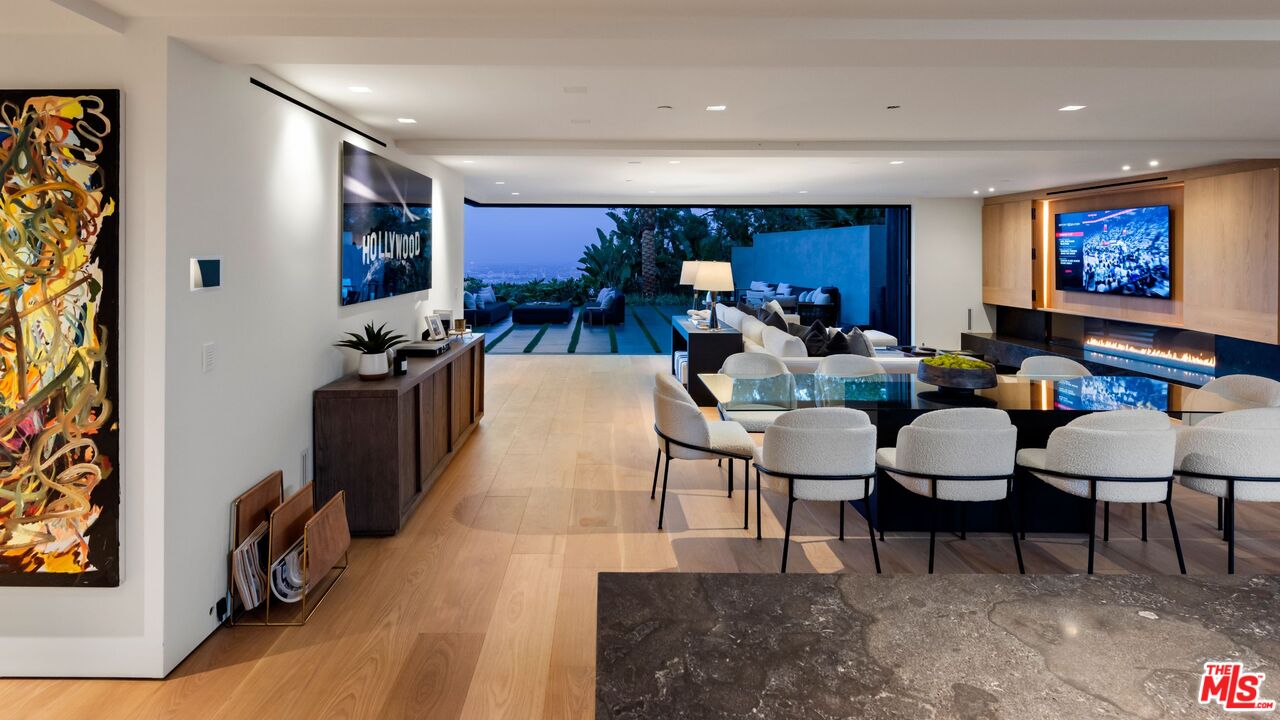 1663 Summitridge Drive Beverly Hills, CA 90210 - Photo 10 of 41 a living room with furniture a rug and a flat screen tv