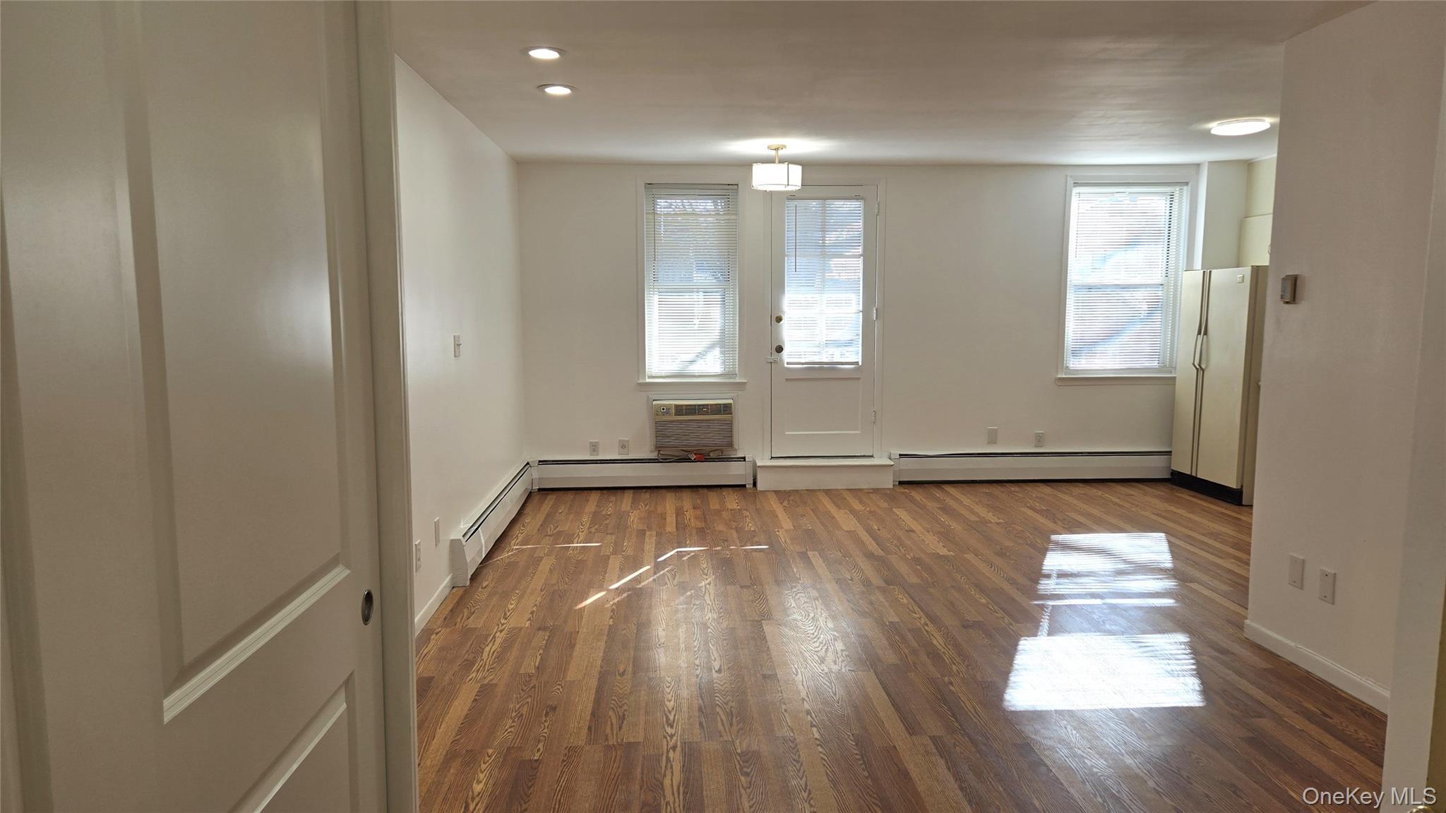 30 Daley Place, Unit 146 Lynbrook, NY 11563 - Photo 4 of 24 a view of empty room with wooden floor and fan