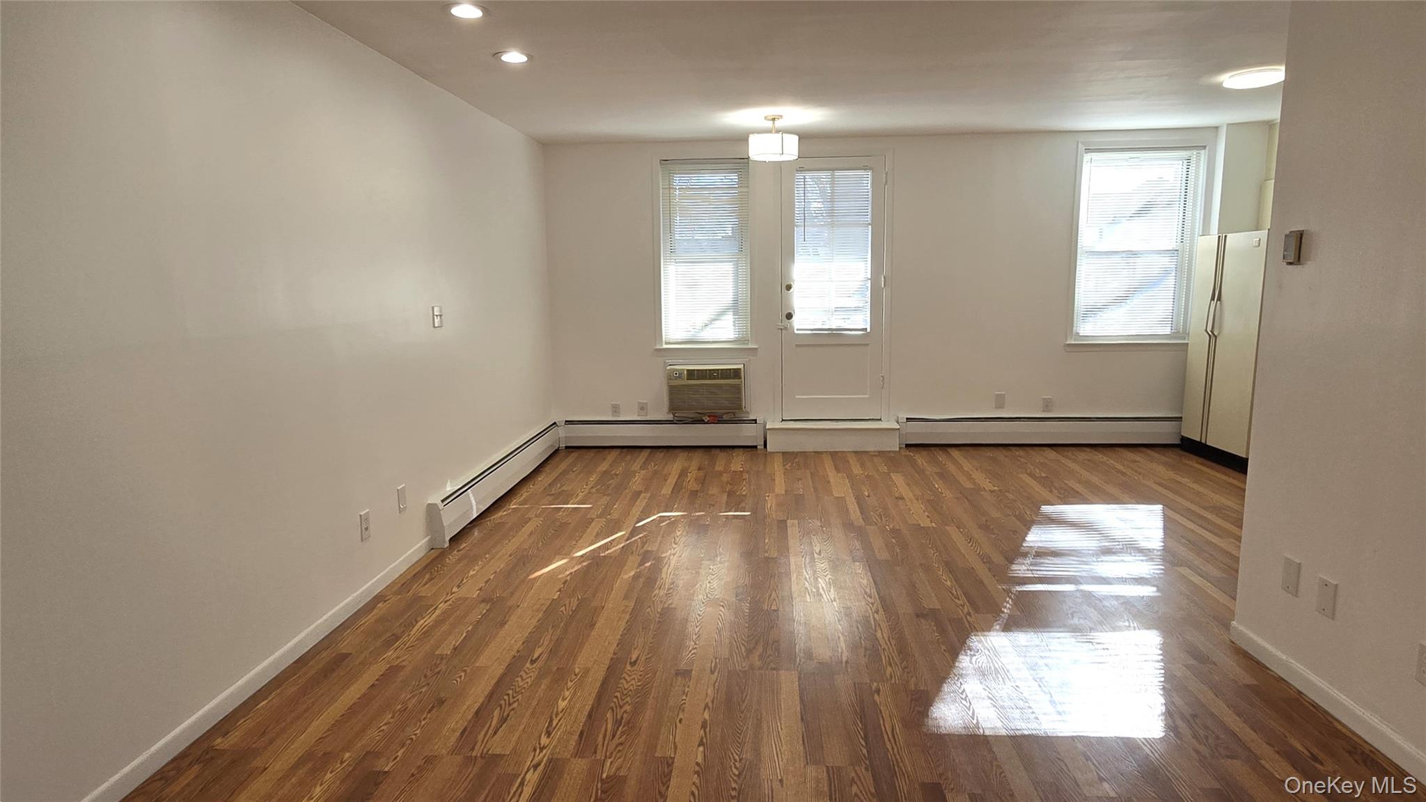 30 Daley Place, Unit 146 Lynbrook, NY 11563 - Photo 5 of 24 a view of empty room with wooden floor