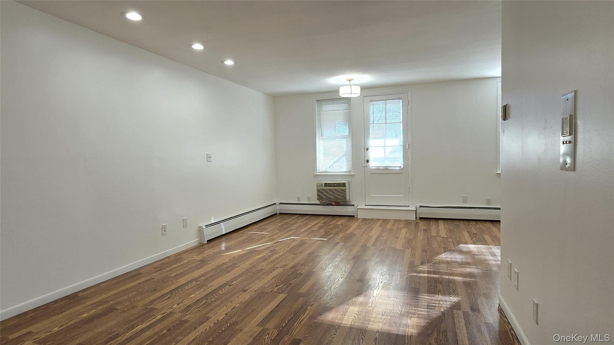 30 Daley Place, Unit 146 Lynbrook, NY 11563 - Photo 6 of 24 a view of empty room with wooden floor and fan