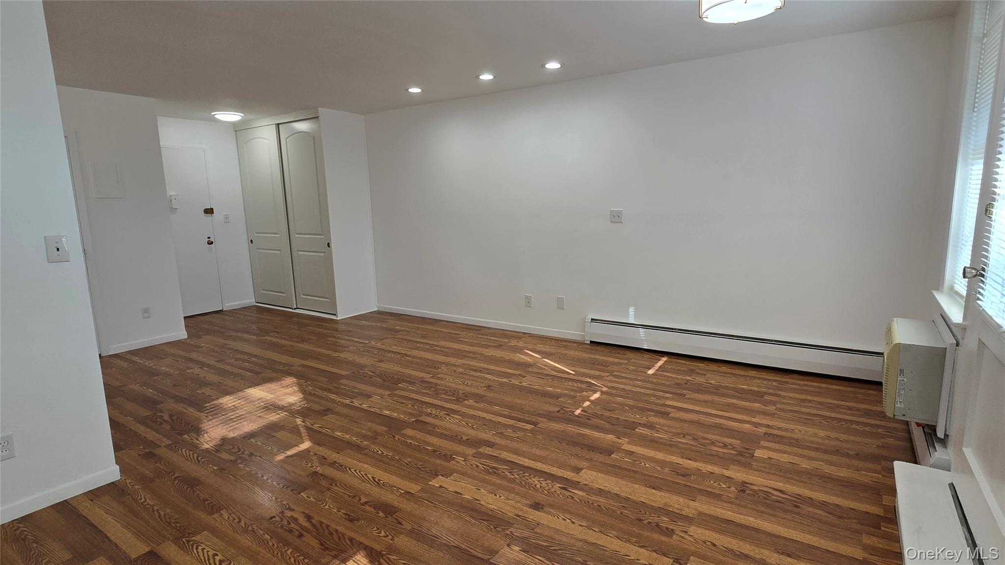 30 Daley Place, Unit 146 Lynbrook, NY 11563 - Photo 8 of 24 a view of empty room with wooden floor
