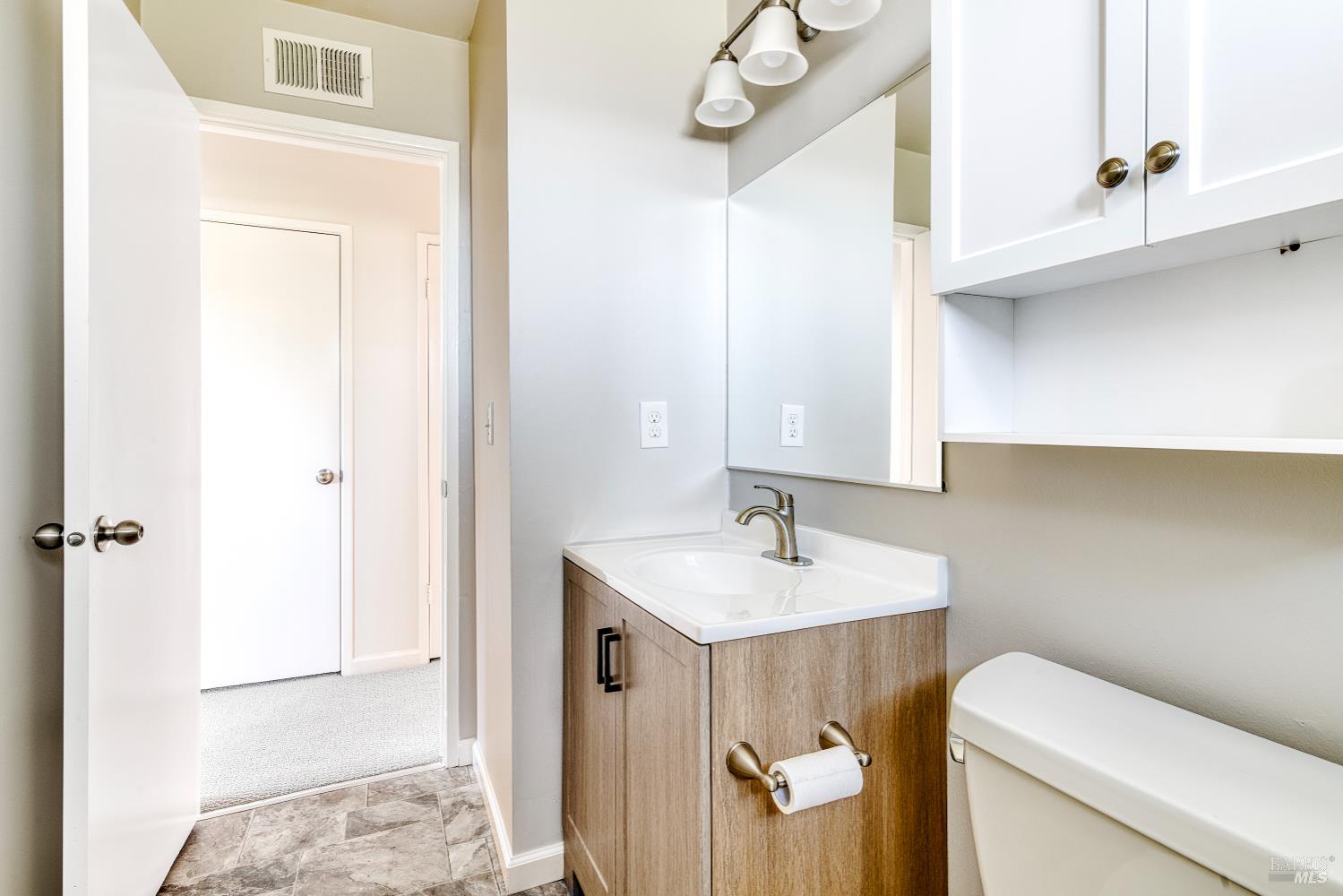 247 Bahia Place San Rafael, CA 94901 - Photo 14 of 22 a bathroom with a sink a toilet and vanity
