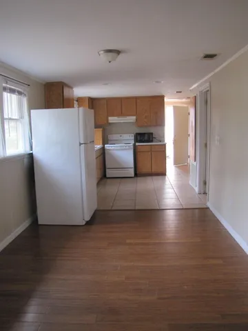 a view of kitchen and wooden floor