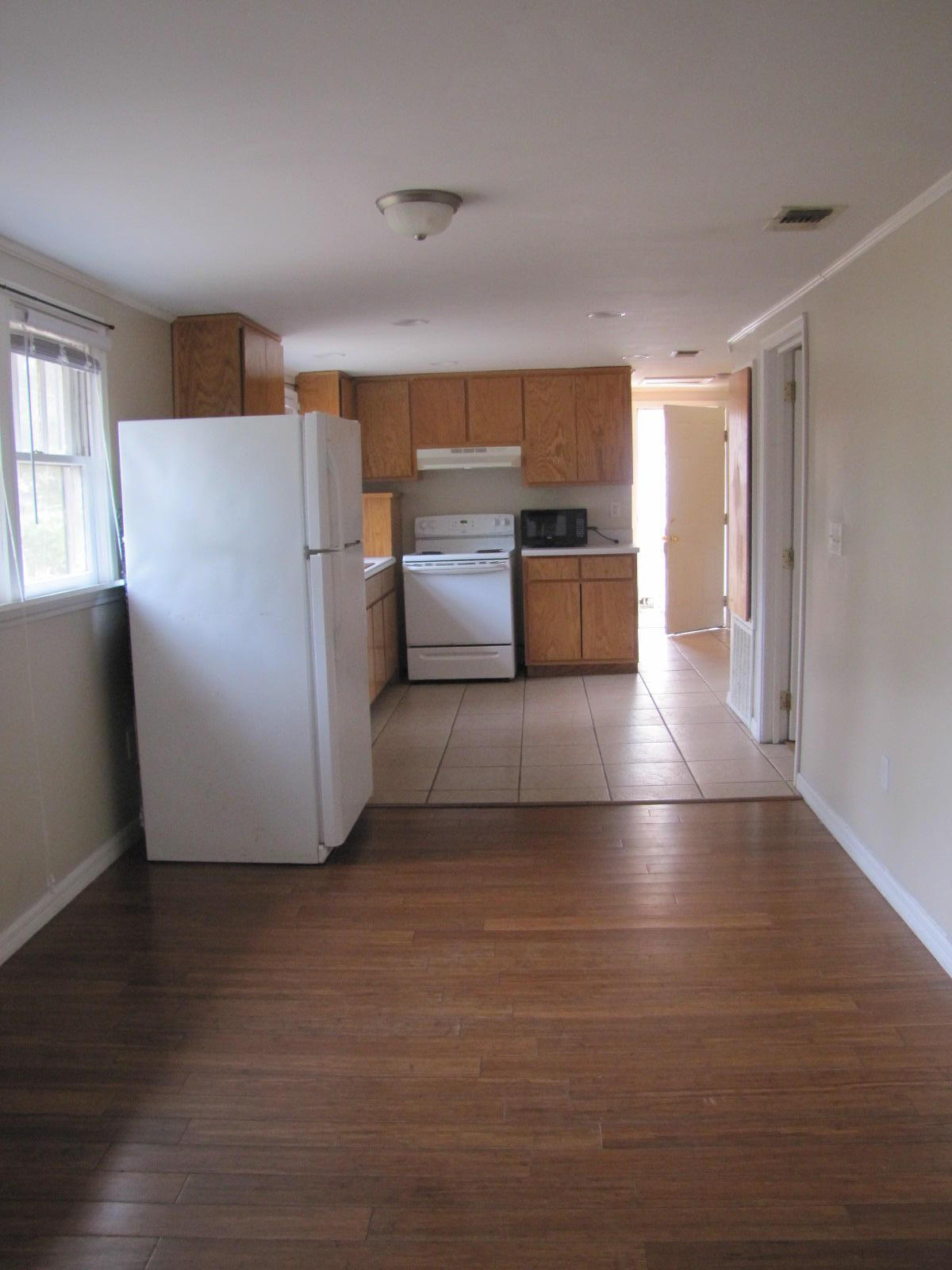 451 East 3rd Avenue Crestview, FL 32536 - Photo 2 of 8 a view of kitchen and wooden floor