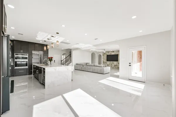 a living room with furniture and kitchen view