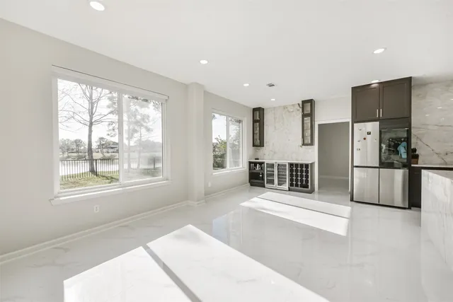 a view of a room with wooden floor and windows