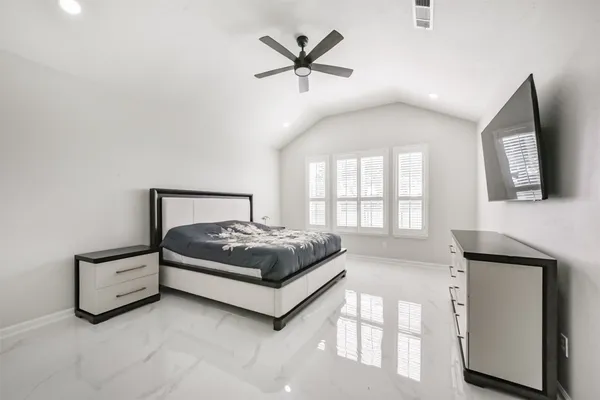 a bedroom with a bed and window