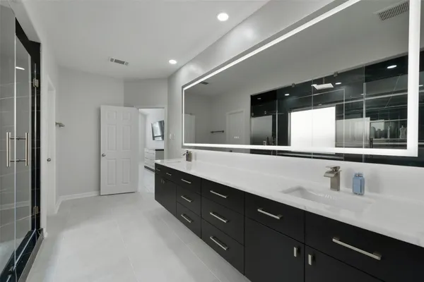a bathroom with a double vanity sink and a mirror