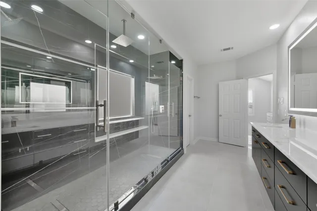 an empty room with wooden floor chandelier fan and windows