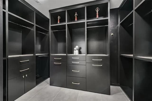 a bathroom with a sink a toilet and a large mirror