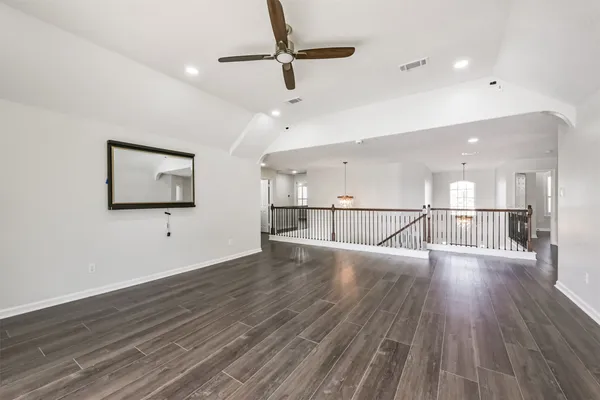 a view of a room with wooden floor and windows