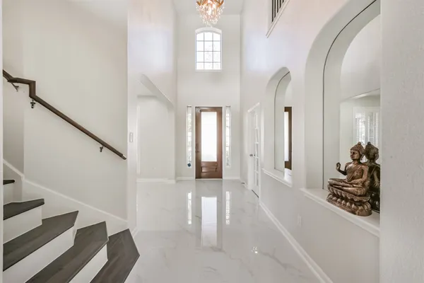 a view of a hallway with wooden floor and entryway