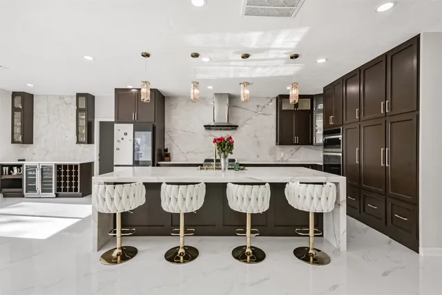 a kitchen with stainless steel appliances granite countertop a stove and a refrigerator