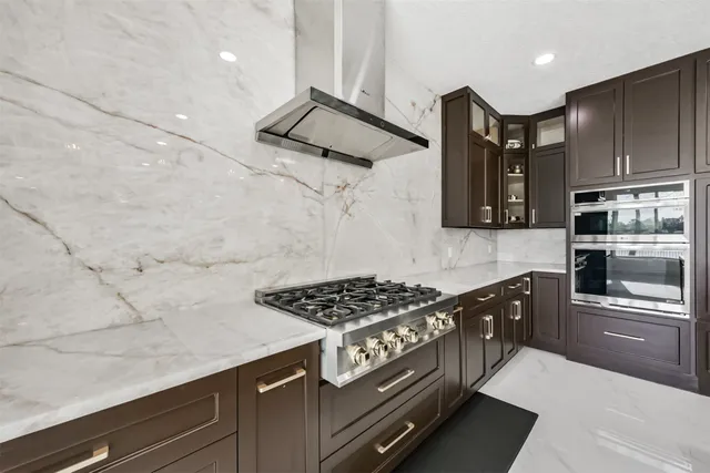 a kitchen with kitchen island granite countertop a sink and refrigerator