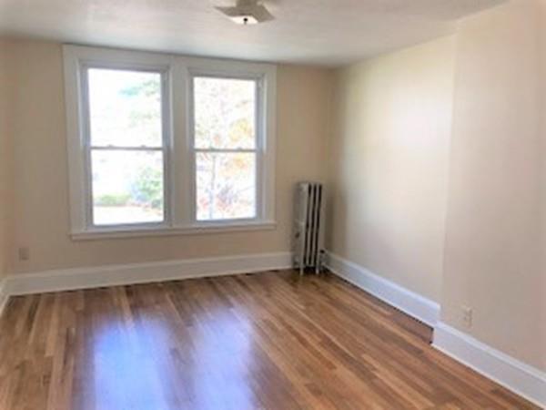 42 Carroll Street Springfield, MA 01108 - Photo 11 of 16 an empty room with wooden floor and windows