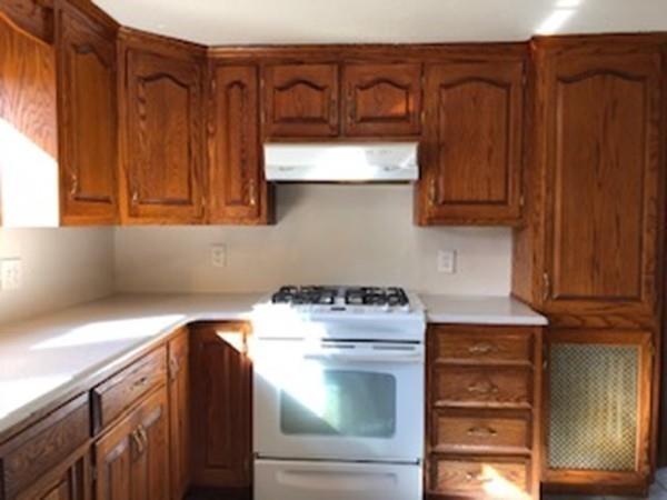 42 Carroll Street Springfield, MA 01108 - Photo 4 of 16 a kitchen with a stove and a cabinet