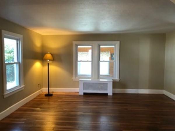 42 Carroll Street Springfield, MA 01108 - Photo 5 of 16 a view of empty room with wooden floor and fan
