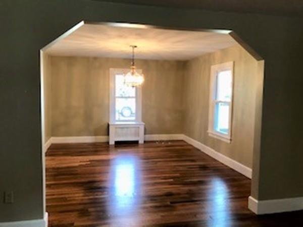 42 Carroll Street Springfield, MA 01108 - Photo 6 of 16 a view of empty room with wooden floor and fan