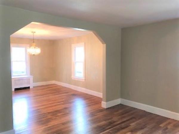 42 Carroll Street Springfield, MA 01108 - Photo 7 of 16 a view of an empty room with wooden floor and a window