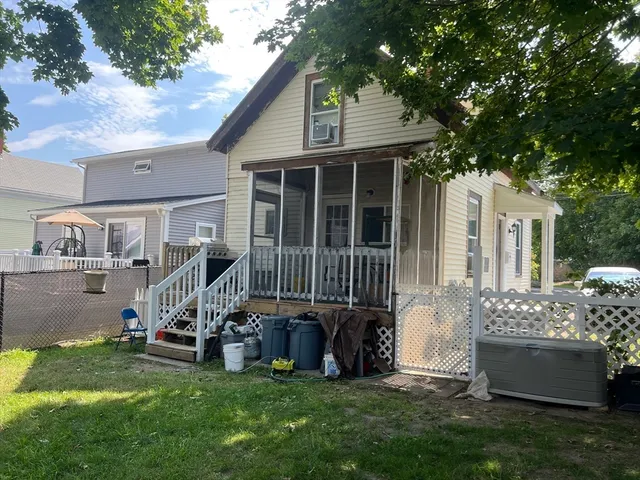 a view of a house with a yard and deck