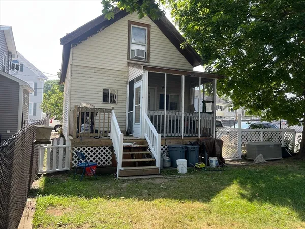a view of a house with a yard and deck