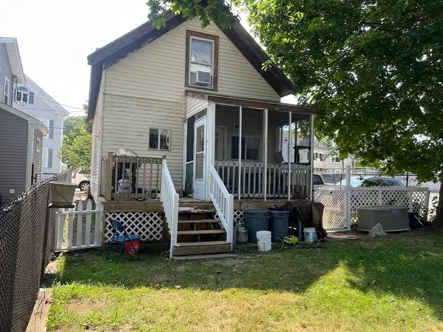 a view of a house with a yard and deck