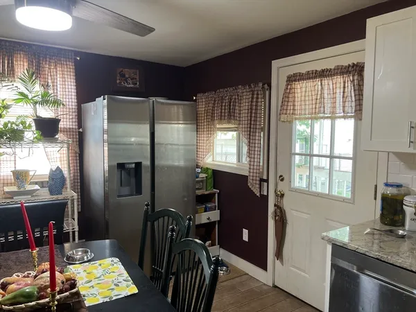 a kitchen with stainless steel appliances granite countertop a refrigerator and a stove