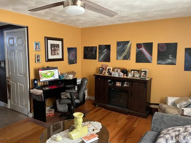 a living room with furniture and wooden floor
