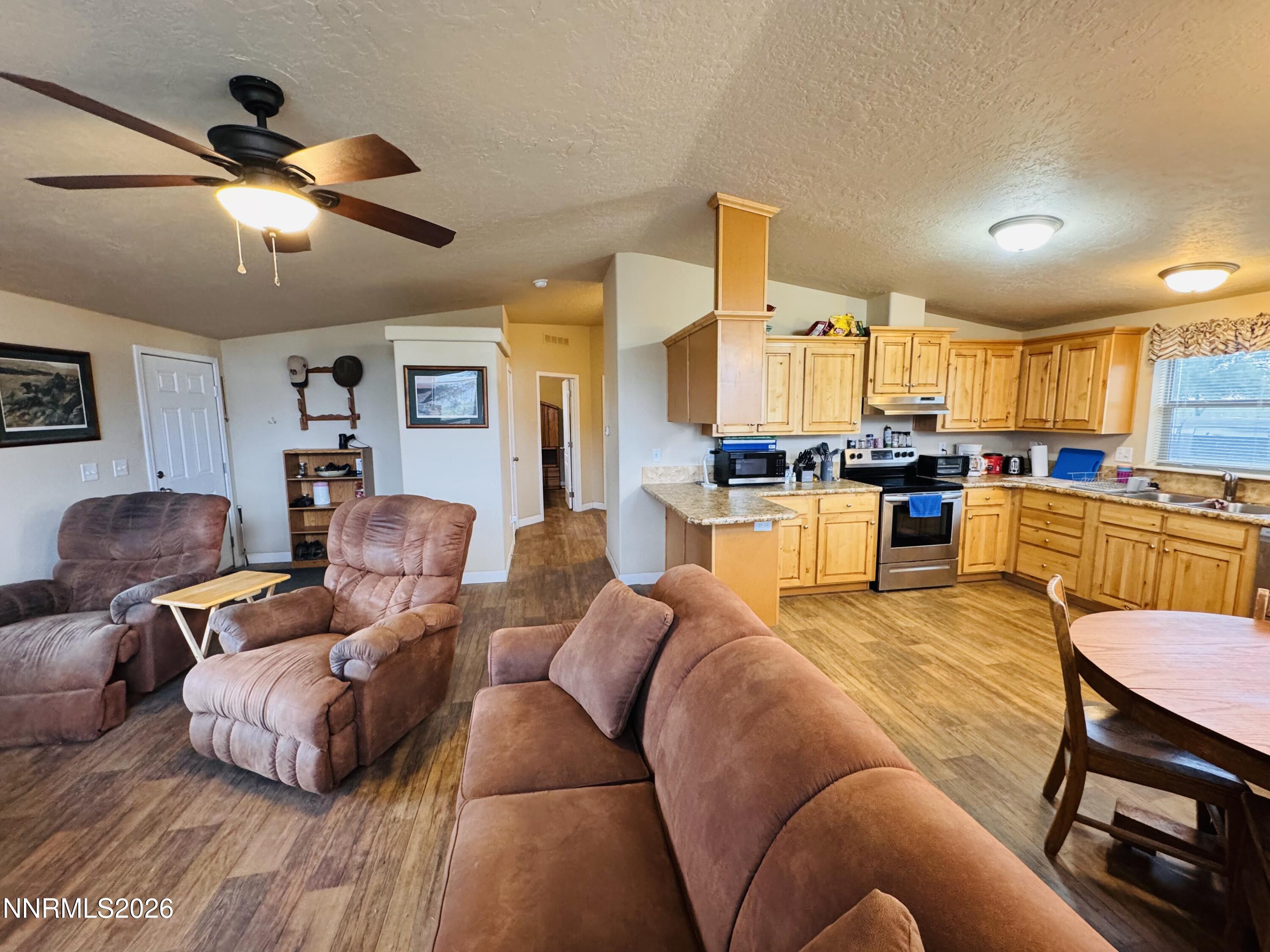 29400 Kings River Road Orovada, NV 89425 - Photo 12 of 40 a living room with furniture kitchen view and a chandelier