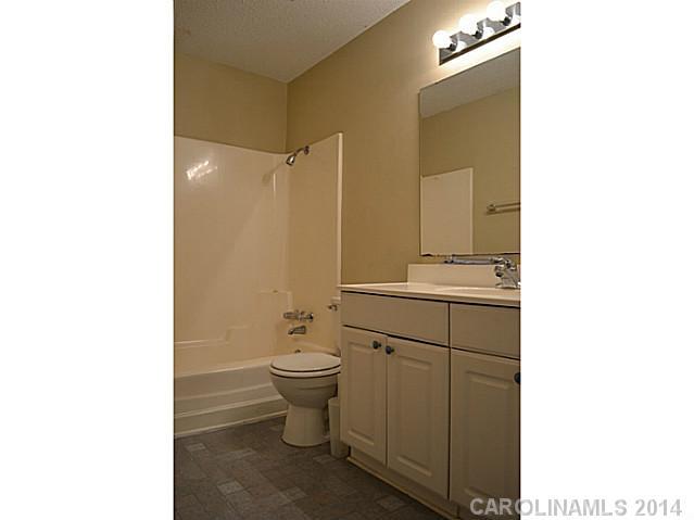 4077 Point Clear Drive Tega Cay, SC 29708 - Photo 11 of 14 a bathroom with a sink a toilet and shower