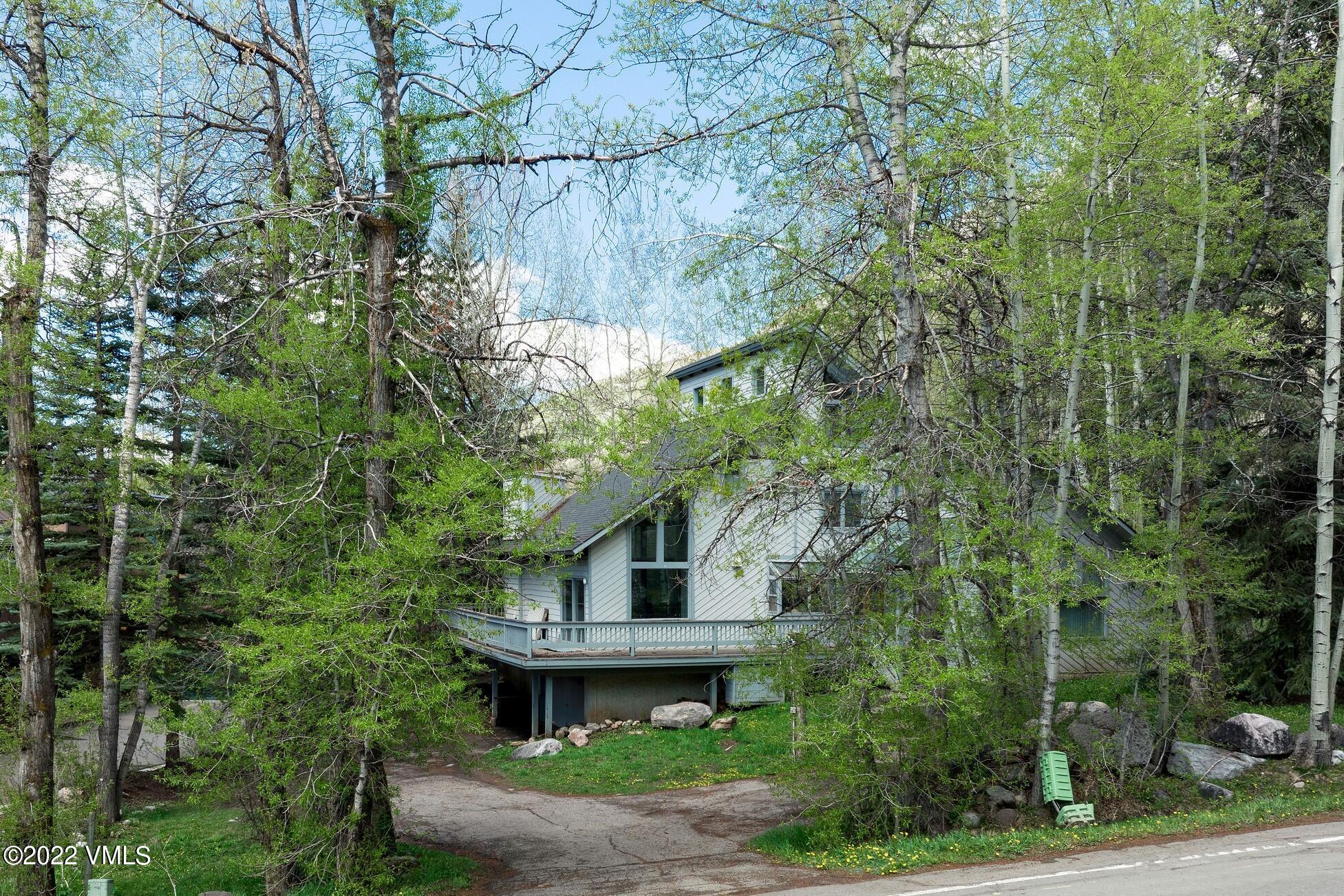 3031 Booth Falls Road Vail, CO 81657 - Photo 1 of 14 a front view of a house with garden