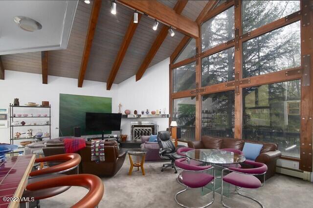 3031 Booth Falls Road Vail, CO 81657 - Photo 12 of 14 a living room with furniture a flat screen tv and a floor to ceiling window
