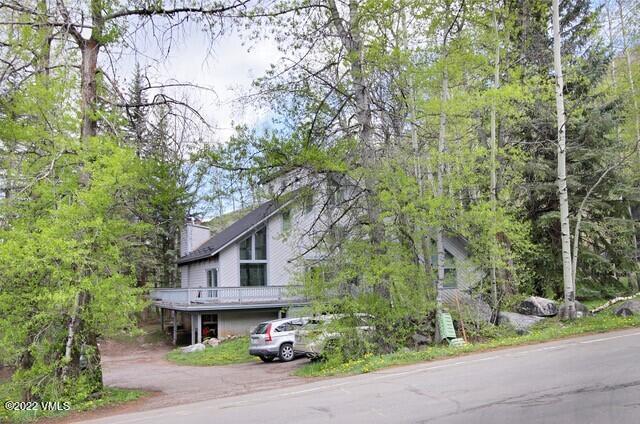 3031 Booth Falls Road Vail, CO 81657 - Photo 9 of 14 a front view of a house with a yard and trees