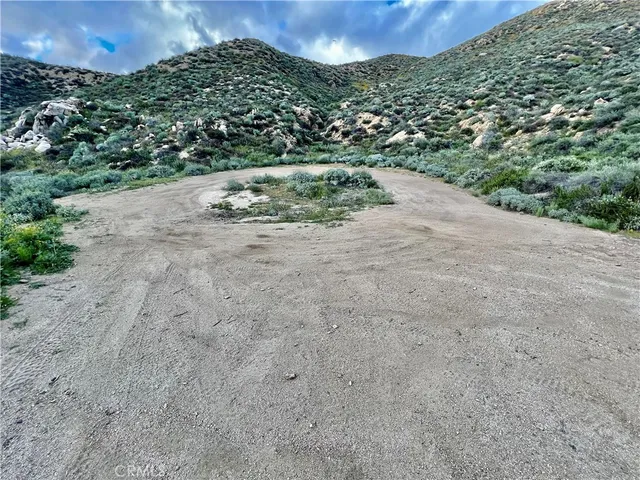 a view of a pathway both side of river with yard in back