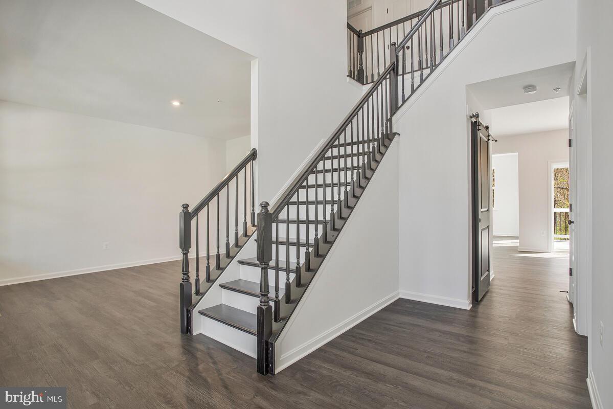 6519 Suitland Road Suitland, MD 20746 - Photo 12 of 18 a view of staircase with wooden floor and white walls
