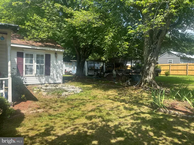 a view of a house with a yard balcony and tree