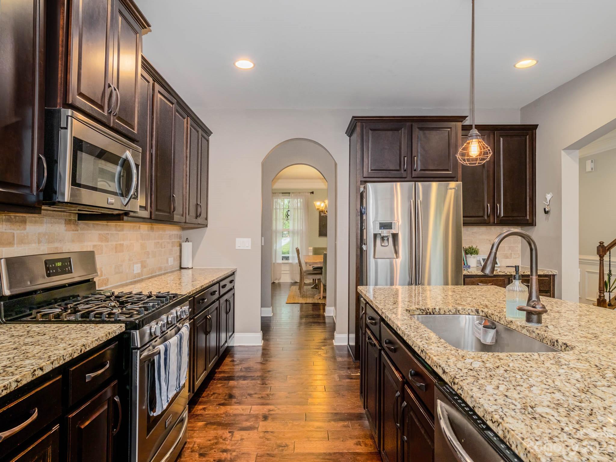 79432 Ridgehaven Road Lancaster, SC 29720 - Photo 3 of 42 a kitchen with stainless steel appliances granite countertop a stove a sink and a microwave