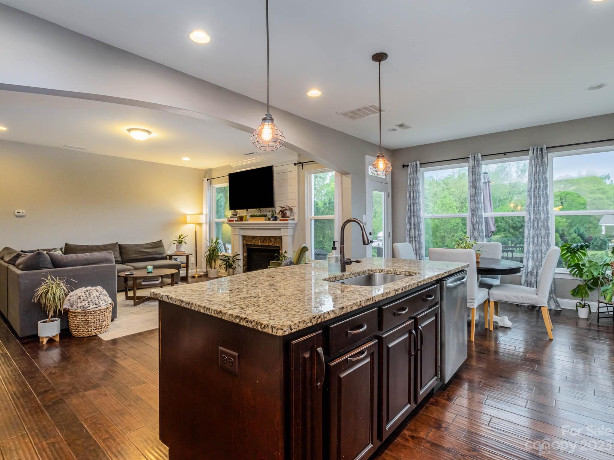 79432 Ridgehaven Road Lancaster, SC 29720 - Photo 4 of 42 a open kitchen with stainless steel appliances granite countertop a kitchen island a stove and a wooden floors