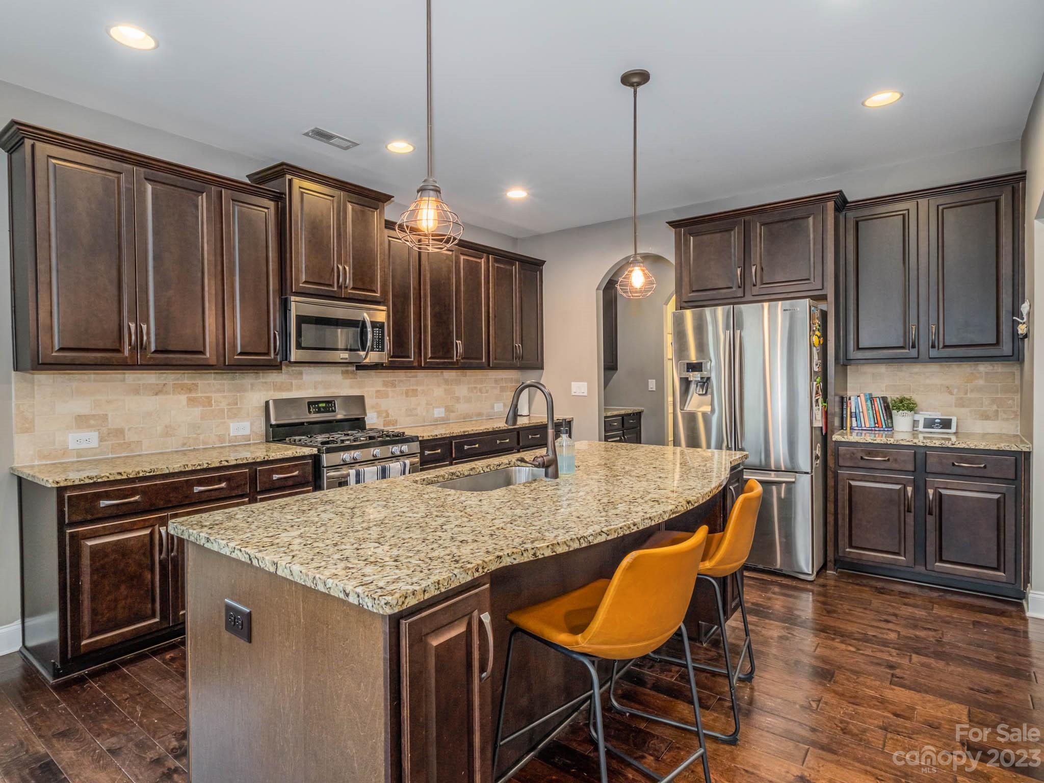 79432 Ridgehaven Road Lancaster, SC 29720 - Photo 5 of 42 a kitchen with stainless steel appliances granite countertop a stove top oven a refrigerator a sink and chairs