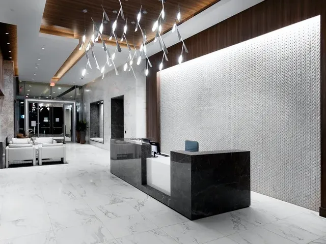 a lobby with furniture and chandelier