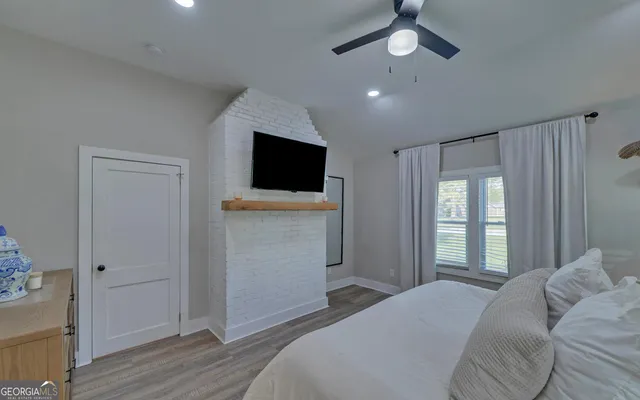 a bedroom with a bed and a flat screen tv