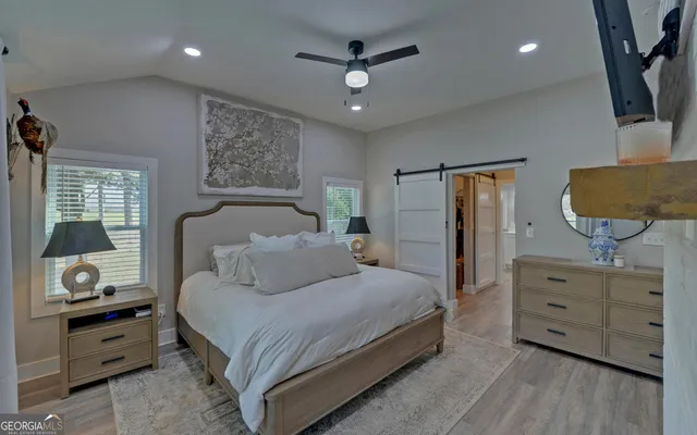 a bedroom with a large bed and a dresser