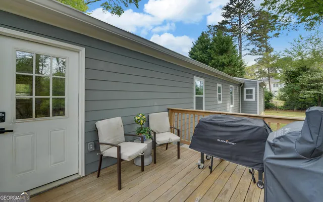 a view of backyard with outdoor seating and trees