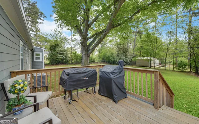 a view of a deck with furniture and a yard