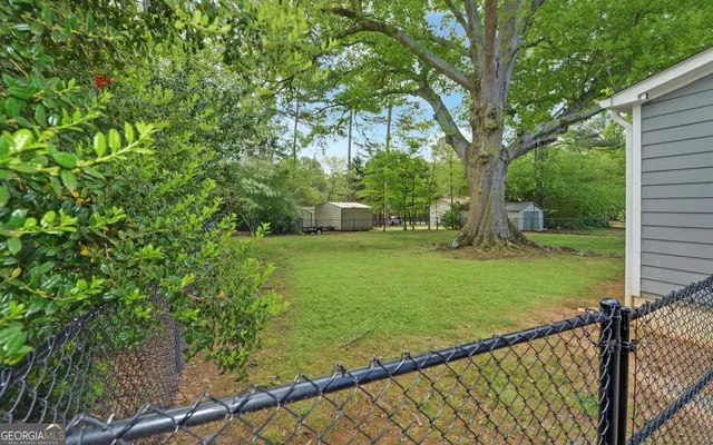 a view of a backyard with large trees